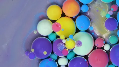 Colorful bubbles and circles dance together in a swirling pattern on a vibrant Stock Footage 288747446