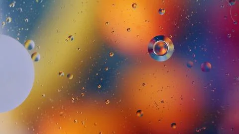 Colorful bubbles suspended in a liquid background create an abstract visual Stock Photos