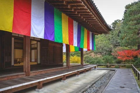 Colorful Buddhist Flags Draped Over a Traditional Temple Porch i Nov 28 2025 Fotos Stock
