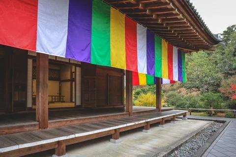Colorful Buddhist Flags Draped Over a Traditional Temple Porch i Nov 28 2025 Fotos Stock