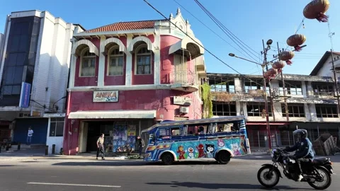 Colorful building with arched windows stands out Видео 345156020
