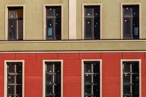 Colorful building facade with rows of windows Stock Photos