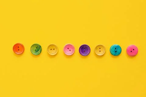 Colorful button on yellow background Stock Photos