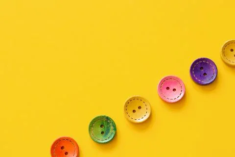 Colorful button on yellow background Stock Photos