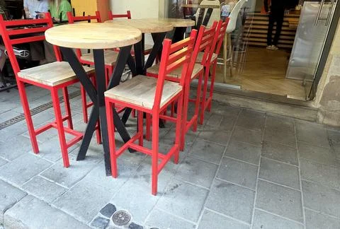 Colorful Cafe Table Stands Invitingly Outside a Bustling Eatery Stock Photos