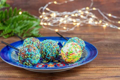 A colorful cake pops up, lying on a table. It is covered with sweet multi Fotos de archivo