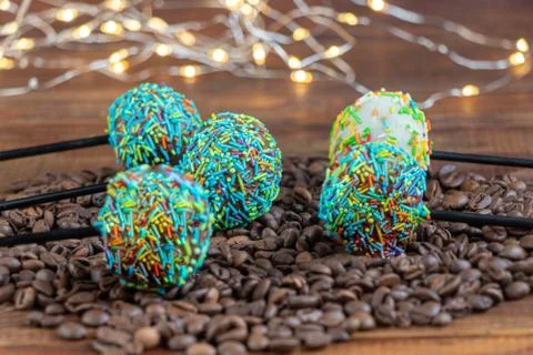 A colorful cake pops up, lying on a table. It is covered with sweet multi Фото