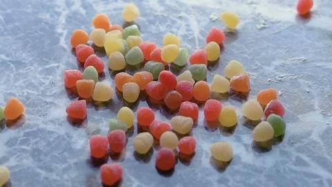 Colorful candies fall in slow motion Видео 98201284