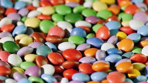 Colorful candy coated chocolates in motion, a vibrant and delicious close u.. Stock Footage 334931355