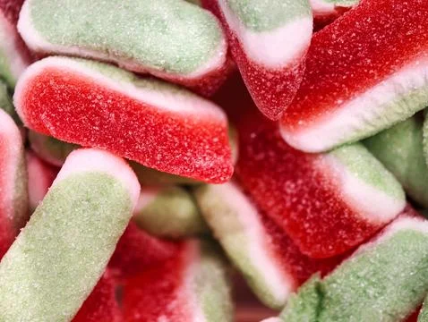 Colorful candy delight, vivid patterned chewy candies with sparkling sugar .. Stock Photos