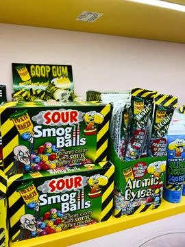 Colorful candy display box featuring Sour Smog Balls and Atomic Bytes on st.. Stock Photos