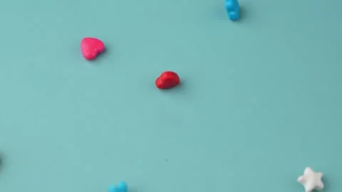 Colorful Candy Falling on Blue Background. Stock Footage 343376169