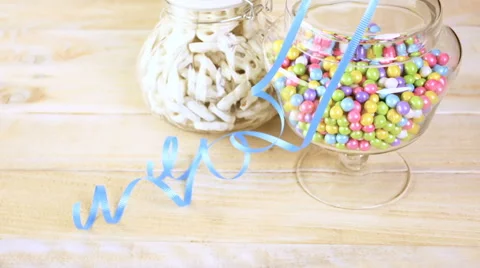 Colorful candy in glass jars of candy sit on the table. Stock Footage 60389060
