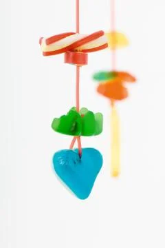 Colorful candy hanging on string Stock Photos