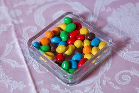 Colorful candy . Multi colored sweets . Colored candy in a glass . Round choc Stock Photos