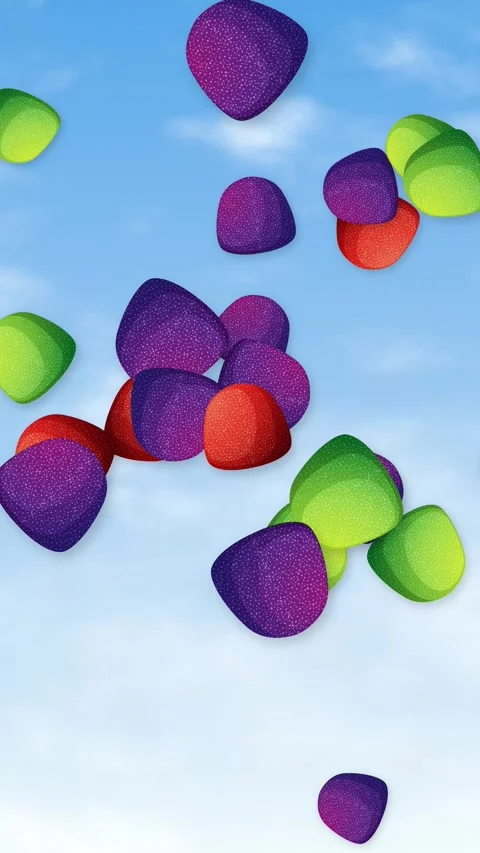 Colorful Candy Pieces Falling Through a Bright Blue Sky Stock Footage 344831550