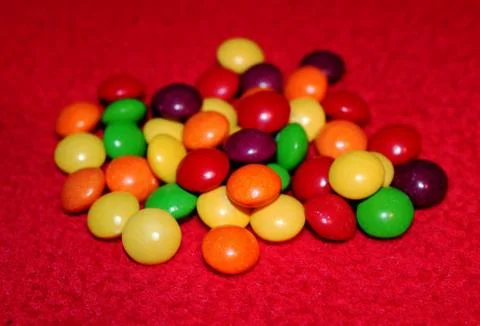 Colorful candy on red background Stock Photos