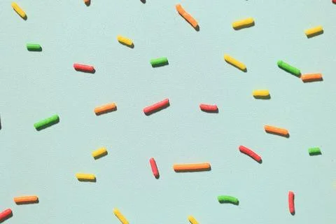 Colorful Candy Sugar Sprinkle on Mint Background Stock Photos