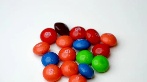 Colorful candy turning on a white background. 8k macro video Видео 233203450