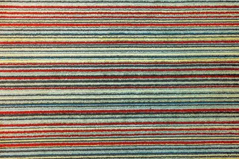 Colorful carpet with horizontal striped pattern in red, yellow, green Stock Photos