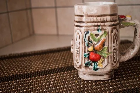 A colorful ceramic empty mug for coffee or tea. Home interior. Stock Photos