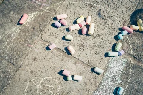 Colorful chalks on pavement. Stock Photos