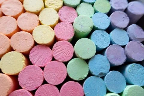 Colorful chalks, pink, green, blue, violet, orange and yellow. Stock Photos