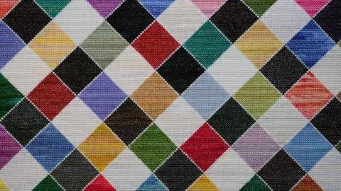 Colorful checkered pattern hand-embroidered in cross-stitch background Foto stock