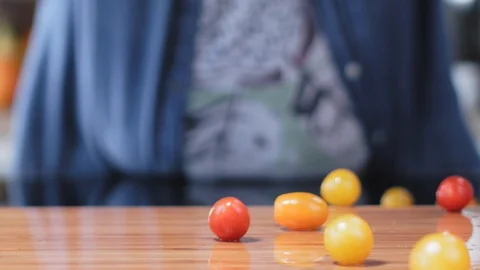 Colorful Cherry Tomatoes Falling On A Kitchen Board Stock Footage 93064132