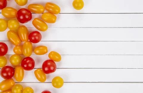 Colorful cherry tomatoes on white table, top view. Stock Photos