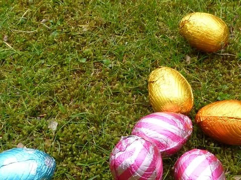 Colorful chocolate Easter eggs on the ground Stock Photos