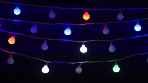 Colorful Christmas holiday lights string blinking isolated on black background Stock Footage 161978322