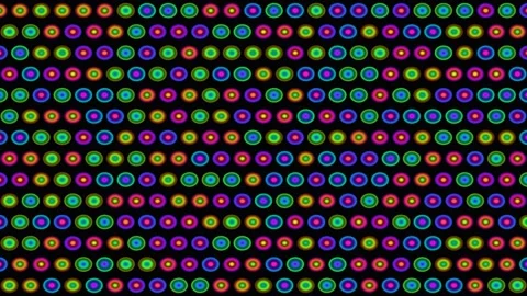 Colorful circles arranged in a pattern on a black Video stock 338558260