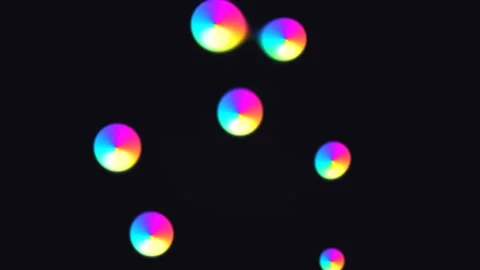 Colorful circles float in dark space creating a vibrant Stock Footage 338229301