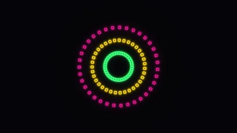 Colorful circular lights create patterns on a dark Stock Footage 338431475