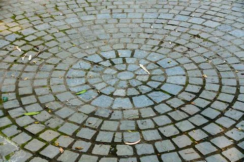 A colorful circular tile pattern on the footpath. Stock Photos