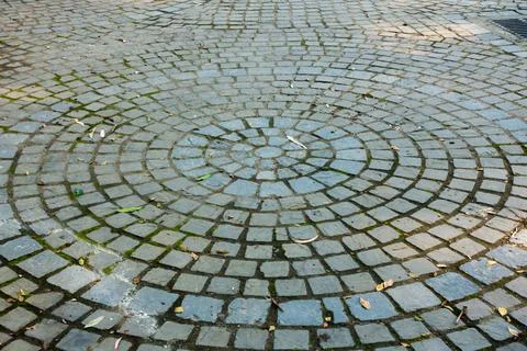 A colorful circular tile pattern on the footpath. Stock Photos