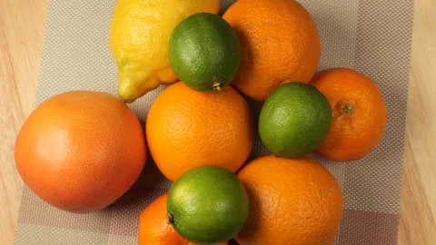 Colorful citrus fruit assortment rotating on a table Stock Footage 343434776