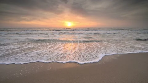 Colorful close up view of a sandy beach at sunrise Stock Footage 131825598