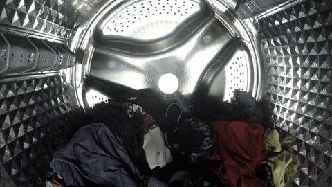 Colorful clothes being washed, rinse and spin inside of the drum of the washer Video stock 124352198