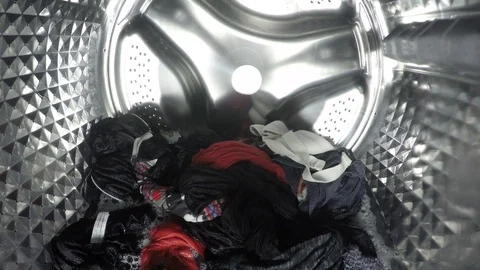 Colorful clothes being washed, rinse and spin inside of the drum of the washer Stock Footage 124352201