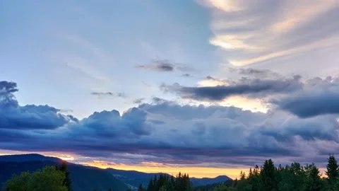 Colorful Clouds in Fast Motion Over Green Hilly and Forest Landscape in Summer Stock Footage 169971897