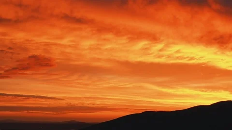 Colorful Clouds Flying over the Ground, Majestic sunset with High Mountains. Stock Footage 121689947
