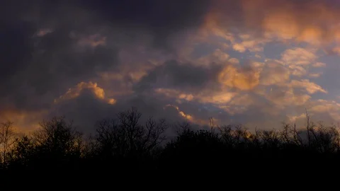 Colorful Clouds over the Forest Time lapse 4k Stock Footage 129372437