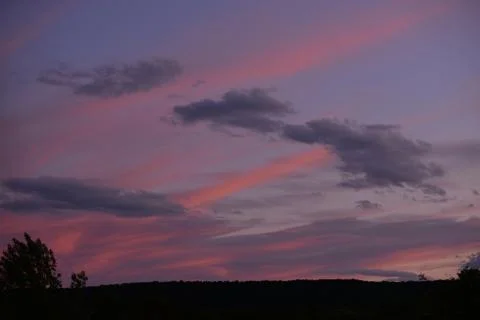 Colorful clouds in the sky at sunset Stock Photos