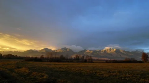 Colorful clouds at sunset in autumn over the High Tatras timelapse video Video stock 136586320