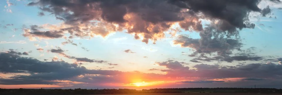 Colorful cloudy sky at sunset. Gradient color. Sky texture, abstract nature b Stock Photos