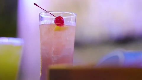Colorful Cocktail with Cherry Garnish at Sunset Bar Stock Footage 320150254