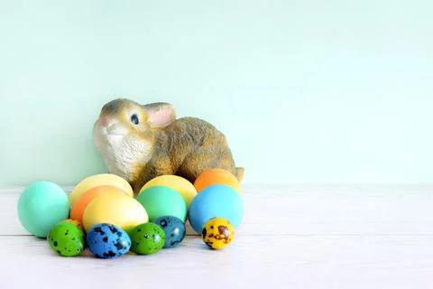 Colorful colored Easter chicken eggs with rabbit bunny toy, spring, Easter co Stock Photos