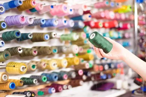 Colorful cones and spools of thread at an atelier.Tailoring, garment industry Stock Photos